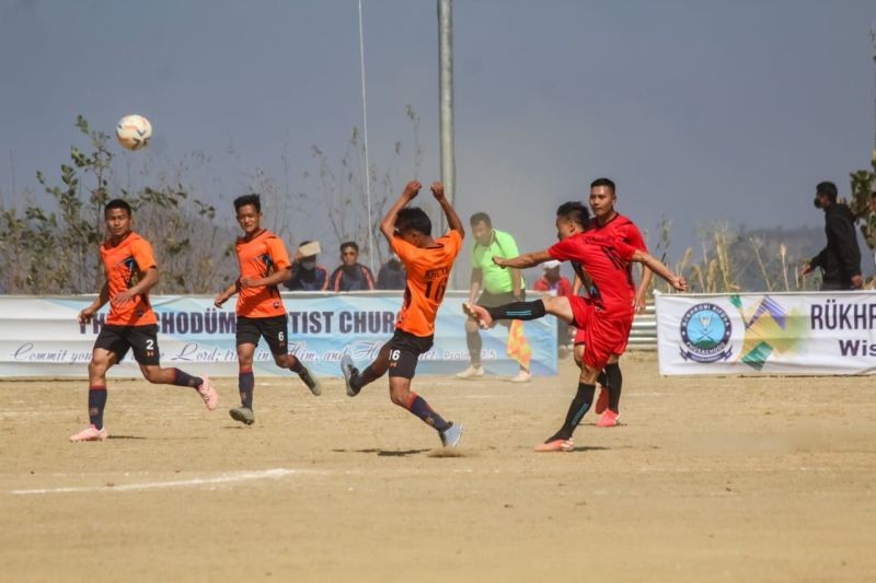 Vekhruto Resu of Thenyizu (red) takes a shot against Thipuzu during a football match on February 3.
